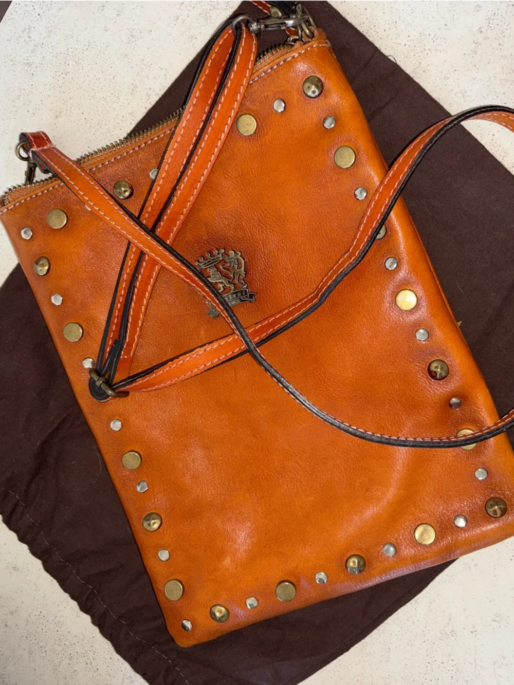 Studded Leather Wristlet Clutch in Cognac with Crest Emblem